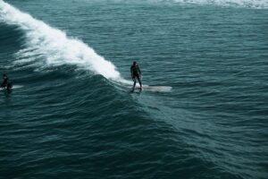 Man Surfing on Beach